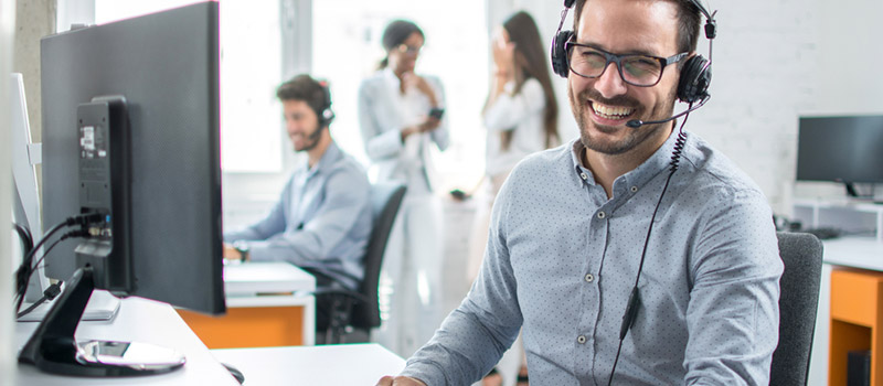 Commercial debt collection agent on phone in office