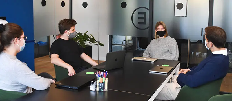 Employees wearing face masks at business meeting in the office