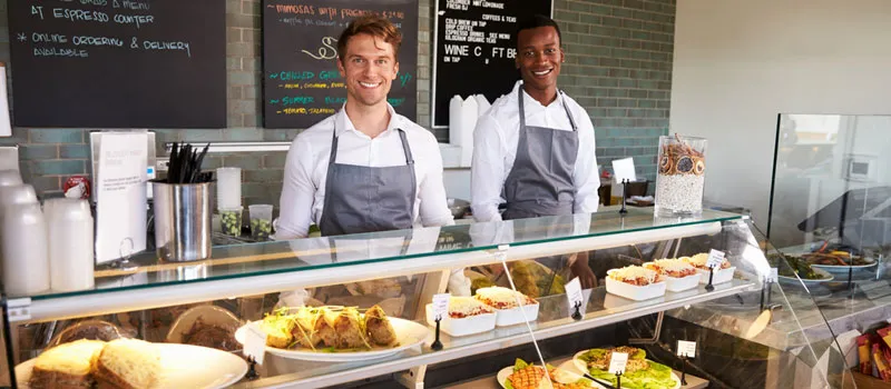 Delicatessen owners behind the counter