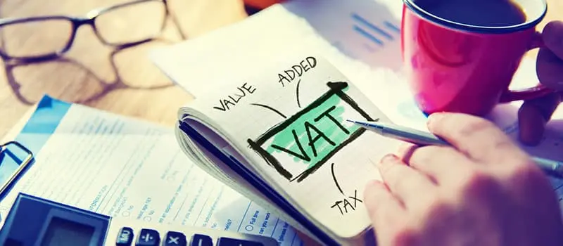 Business owner calculating VAT (Value Added Tax) bill