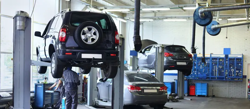 Cars getting serviced in local garage.