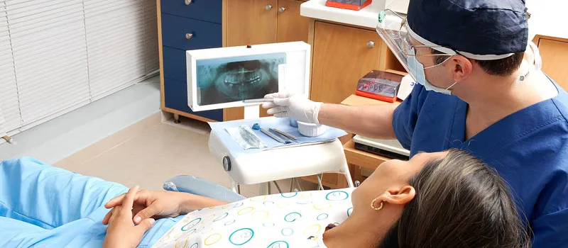 Dentist showing the results of the X-ray to patient