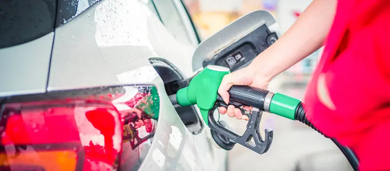 Customer filling up car with fuel at a petrol station