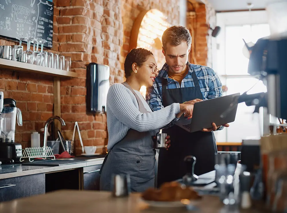 Small business owners calculating factor rate on a business loan