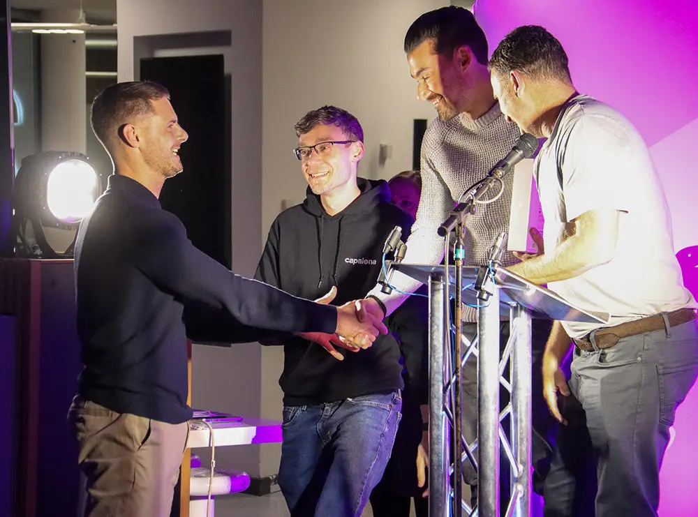 Tristian Griffiths from Your Empowered Mindset accepting the prize from Capalona