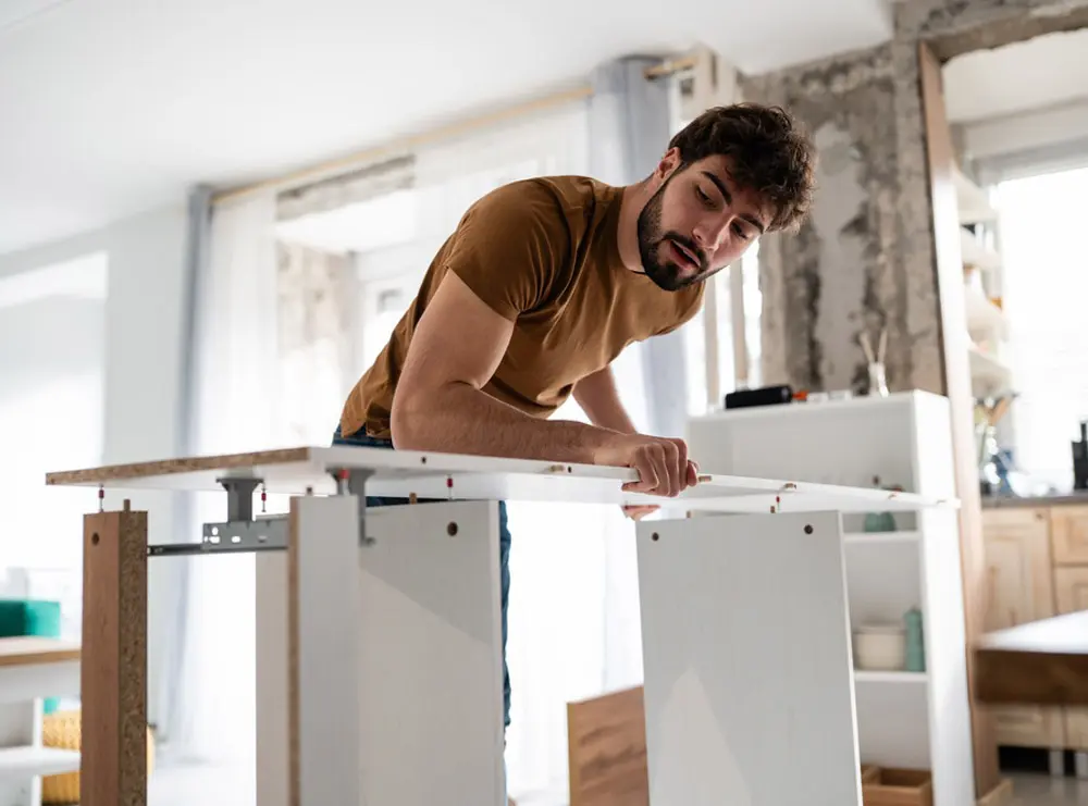 Taskrabbit handyman assembling flat pack furniture for a customer